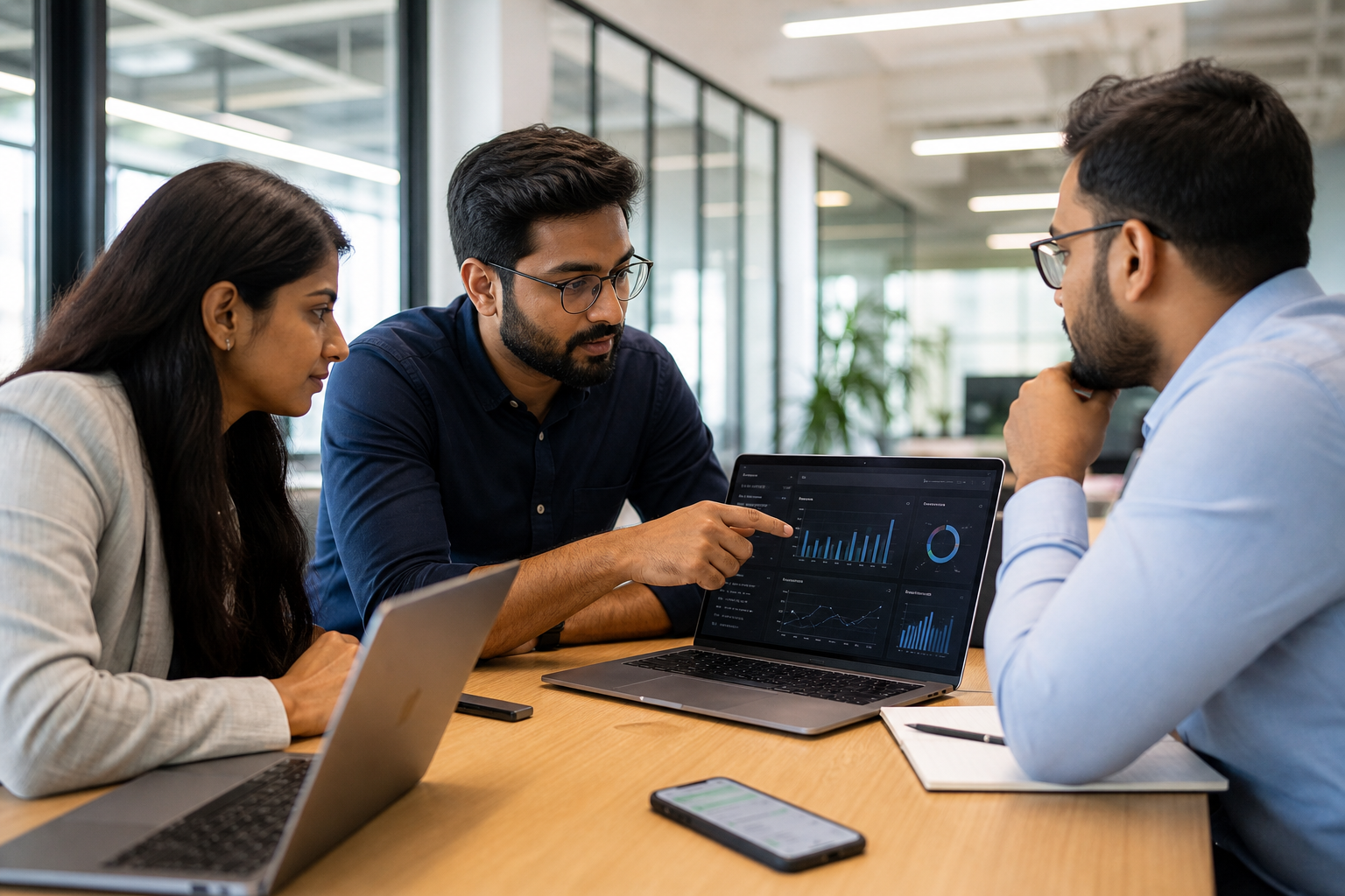 Indian founder reviewing WhatsApp performance dashboard with team